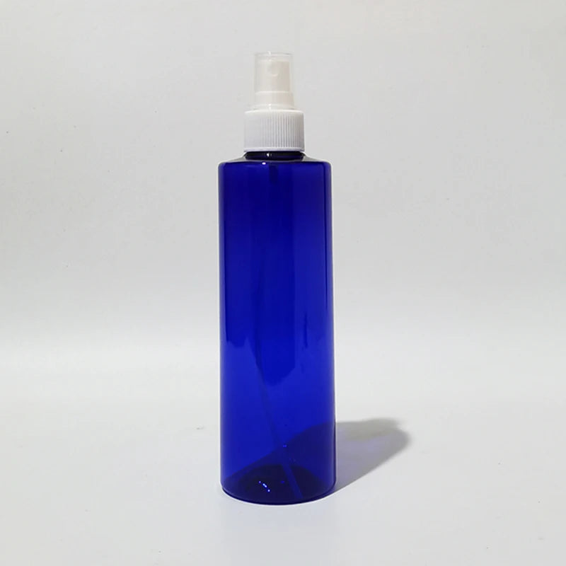 Blue empty round spray bottle with a white sprayer and clear cover