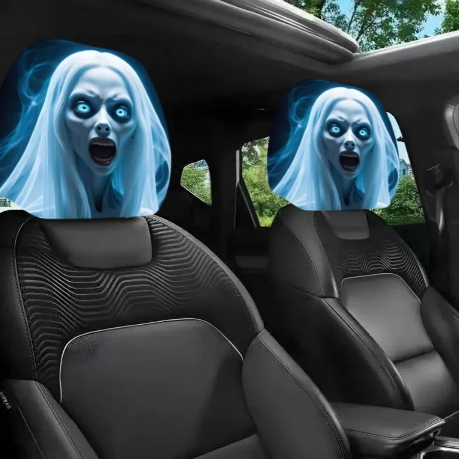 Two car headrest covers featuring a glowing blue ghost face design, shown installed on the front seats of a black car interior.
