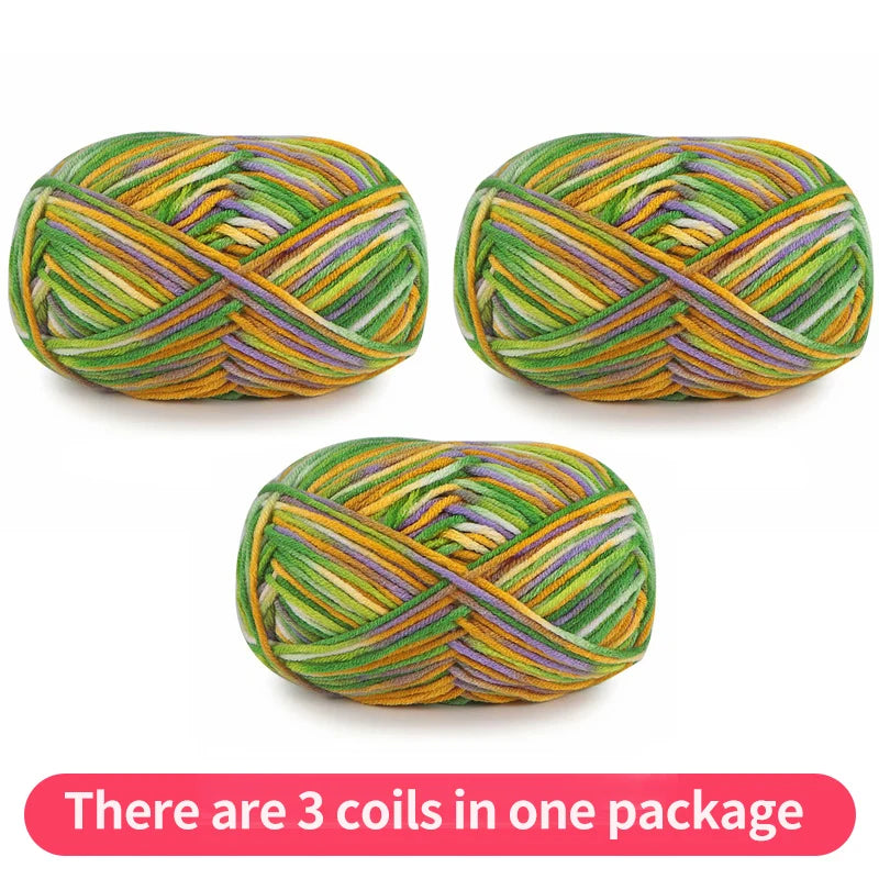 Three variegated yarn skeins in green, gold, purple and white, shown as one package.