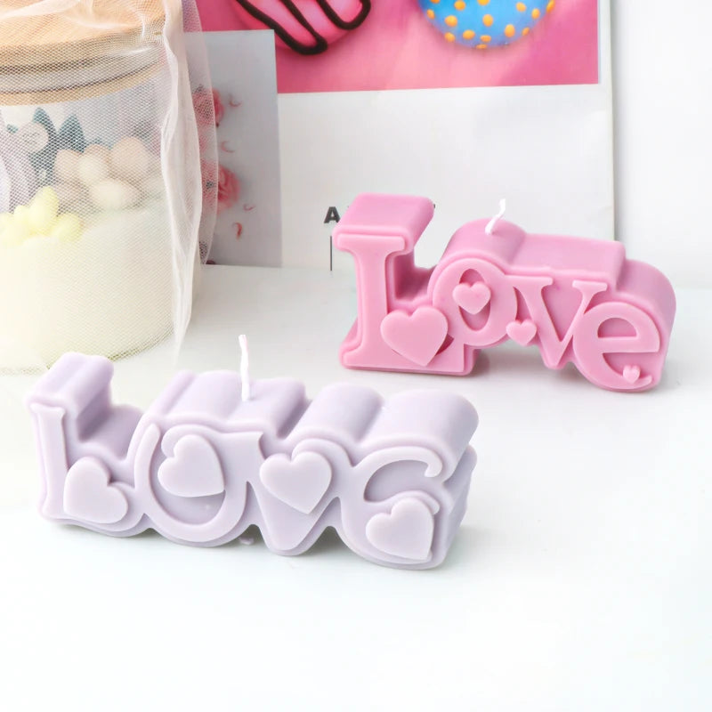 Pink and lavender Love lettering example candles with raised heart details