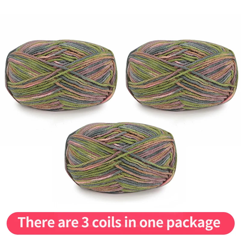 Three muted variegated yarn skeins in olive, gray, peach and mauve, shown as one package.