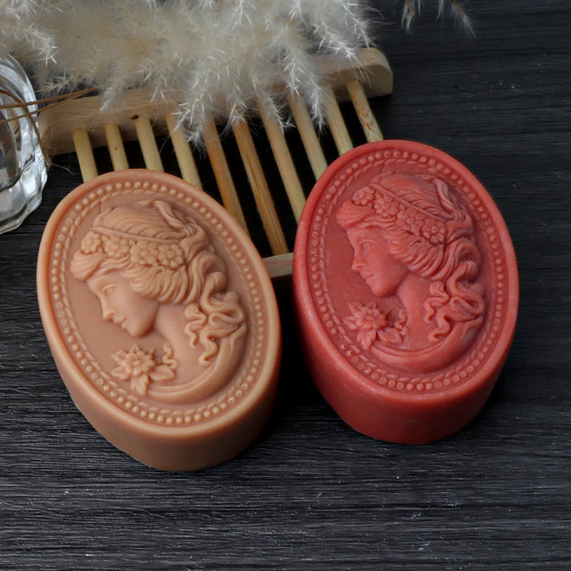 Tan and red oval soap casting examples with woman-profile cameo relief and beaded borders
