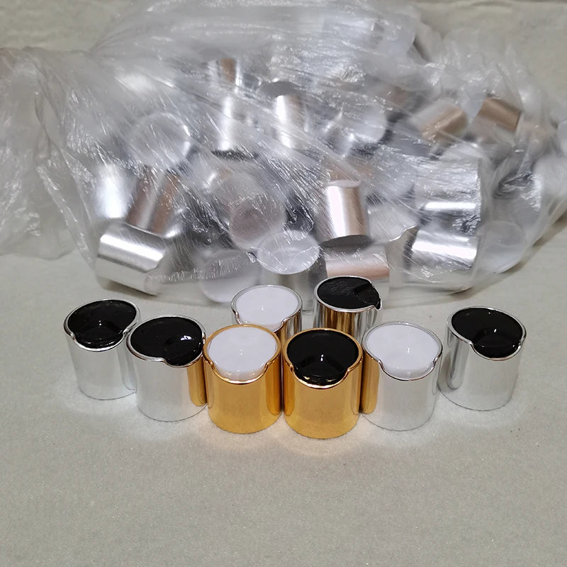 Gold-tone and silver-tone bottle disc caps with black and white inserts