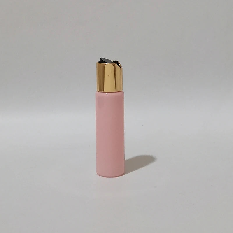 Pink PET bottle with gold-tone disc-top cap and black insert, pink-1