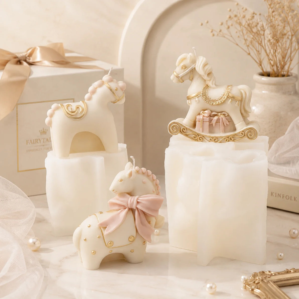 Three ivory horse casting examples arranged around white silicone molds