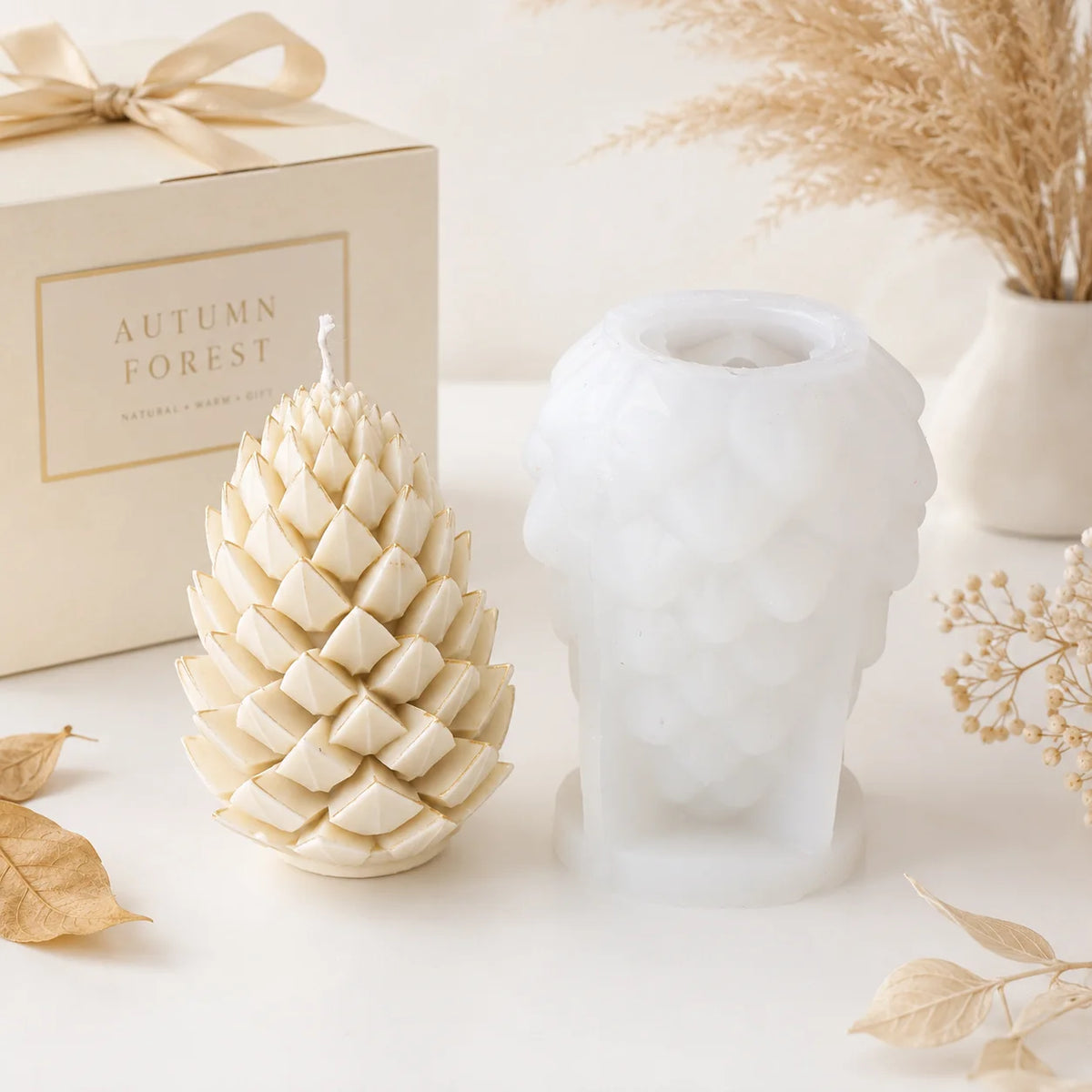 Tall ivory pinecone example candle beside its white silicone mold