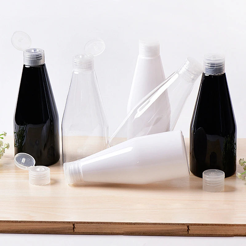 White, clear and black tapered bottles with clear flip-top caps