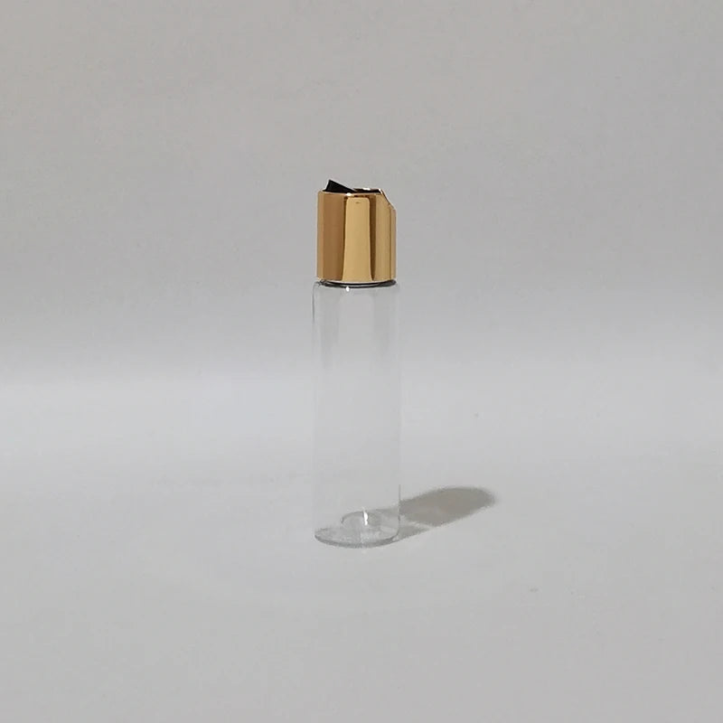 Clear PET bottle with gold-tone disc-top cap and black insert, clear-1