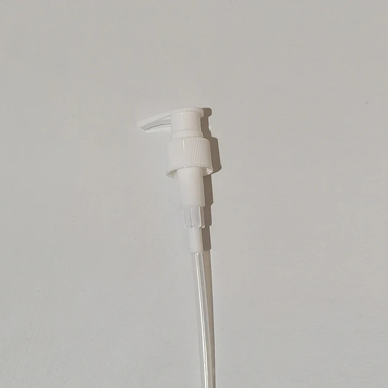 White lotion pump dispenser with a long clear dip tube
