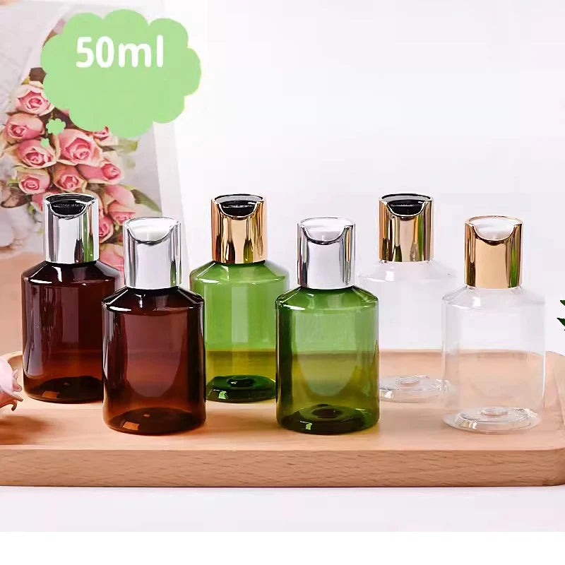 Empty brown, green and clear bottles with gold-tone and silver-tone disc-top closures