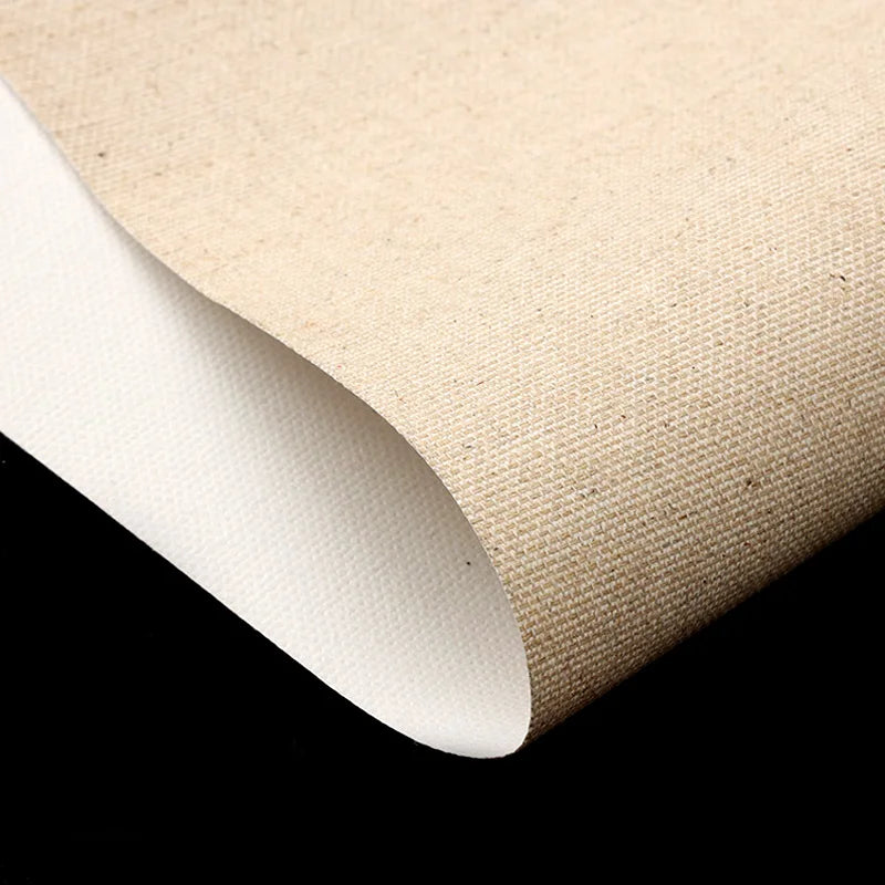 A close-up of a rolled beige textured material, canvas showing its white reverse side against a solid black background.