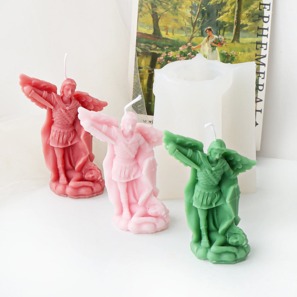 Three colored archangel example candles arranged in front of a white silicone mold