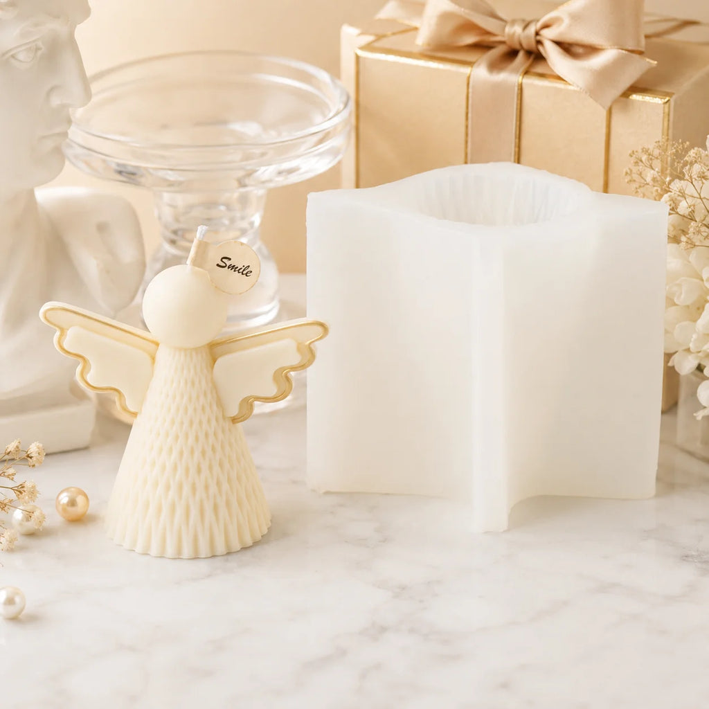 Ivory textured angel example candle with gold-colored wing outlines beside a white silicone mold