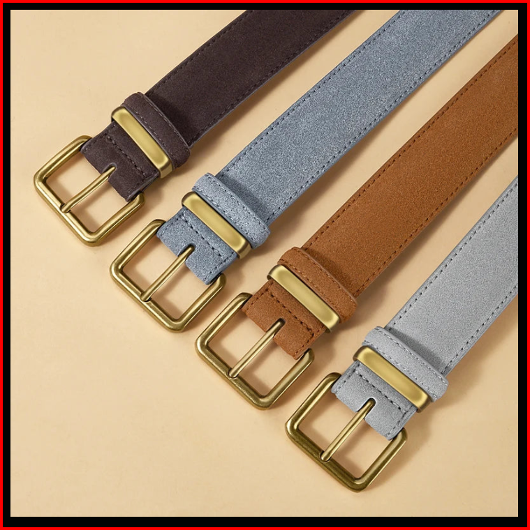 Close-up of suede belts with vintage gold-tone pin buckles